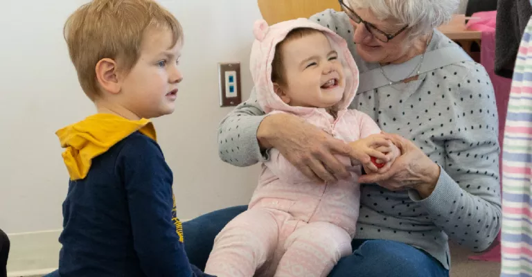 A woman, a baby and a boy at a storytime.