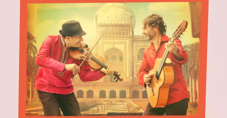 A musician playing a violin and a musician playing an acoustic guitar. In the background is an Indian temple.