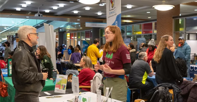 Patron and staff talking at an event.