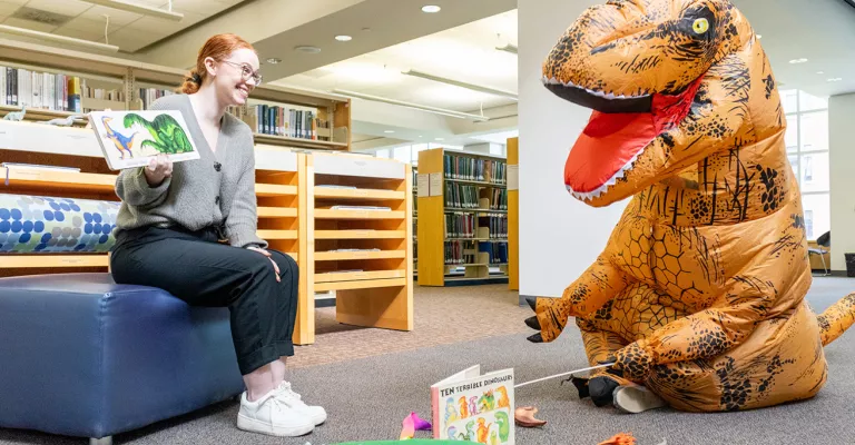 Librarian reads to a Dinosaur