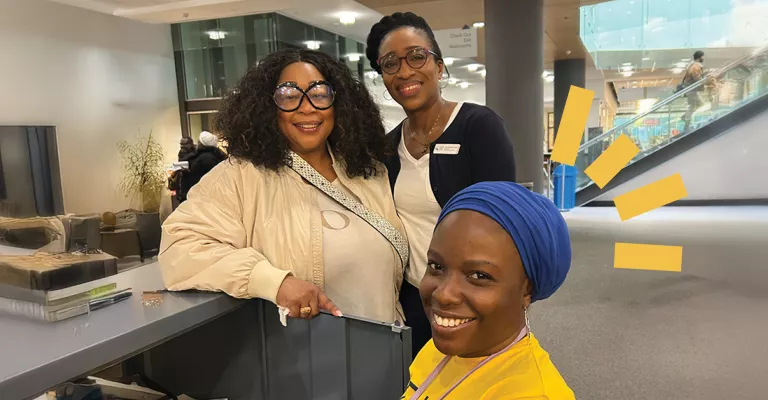 3 people stand on the main floor on central Library 