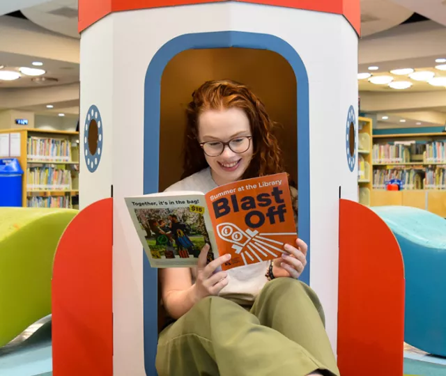 Library staff reading our summer flyer
