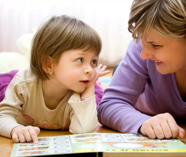 Adult and child reading a book