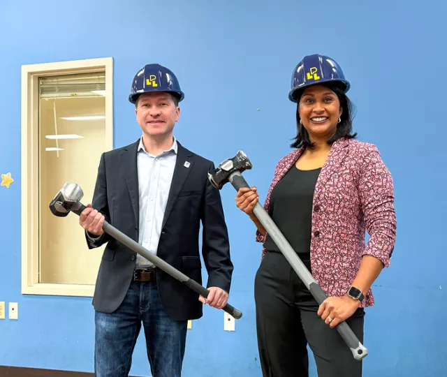 Ward 7 Councillor Corrine Rahman and Mayor Josh Morgan hold sledgehammers at Sherwood library.