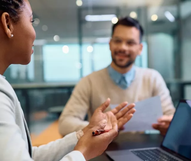 A financial advisor counselling 2 people 