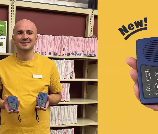 A Visiting Services Librarian holds up two new envoy players.