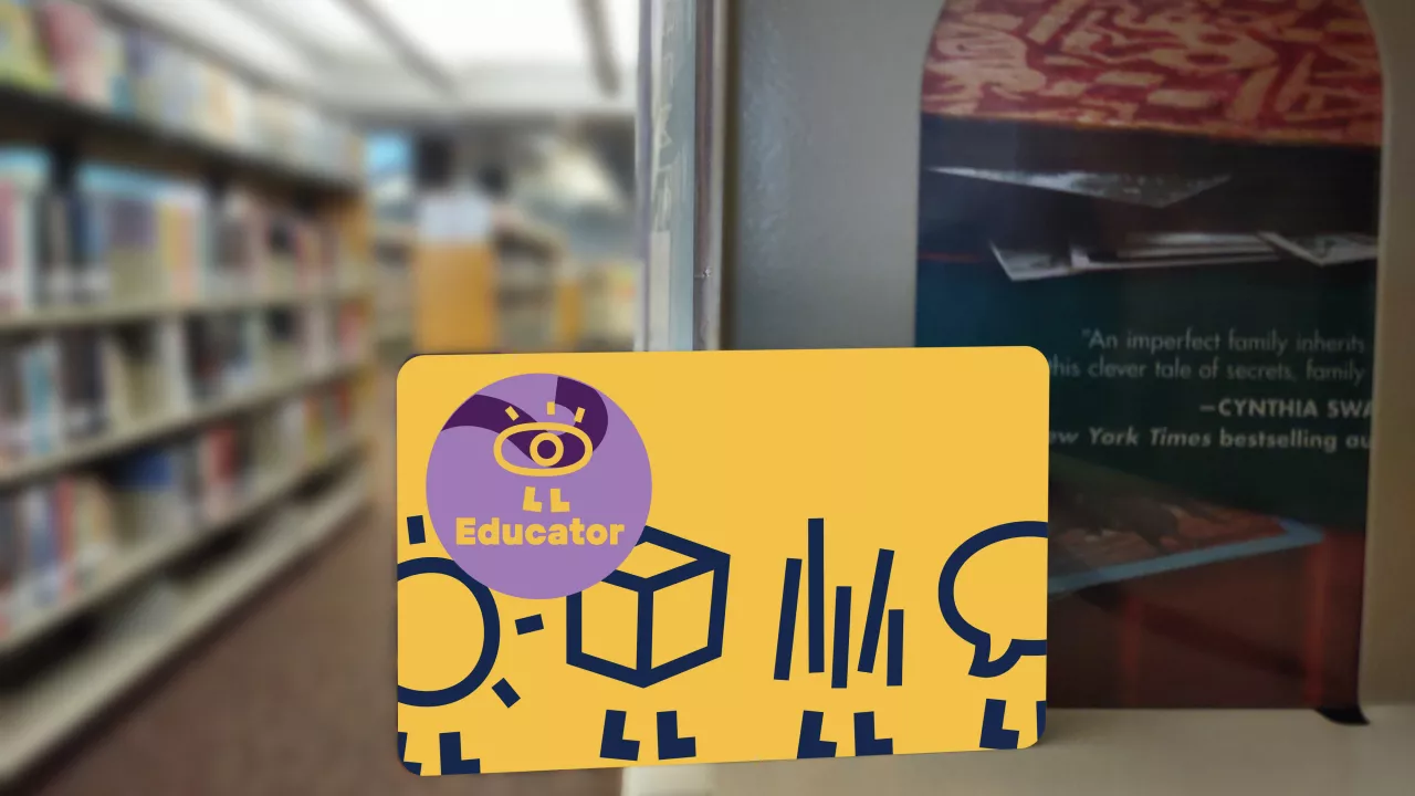 a yellow library card with a educator sticker