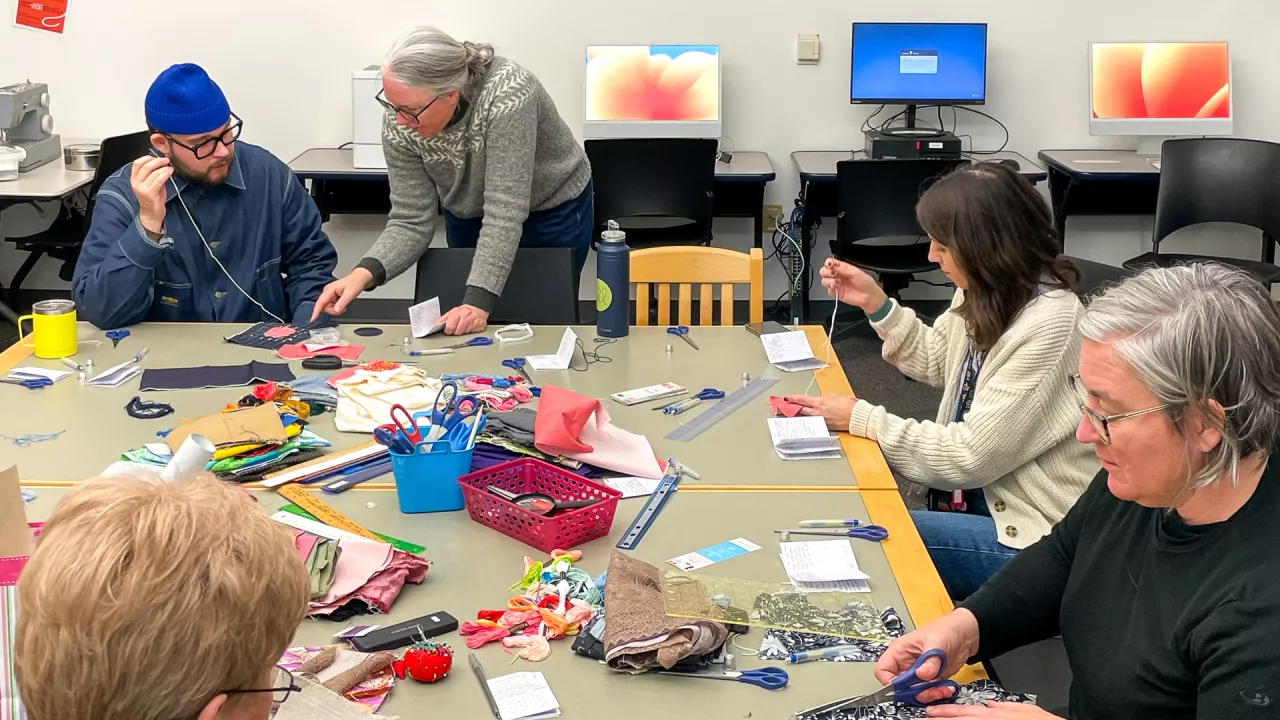 Patrons gathered around a table in the Labs doing arts and crafts