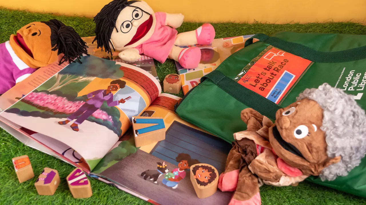 The contents of the Let's Talk About Race Toolkit including puppets, toys and books