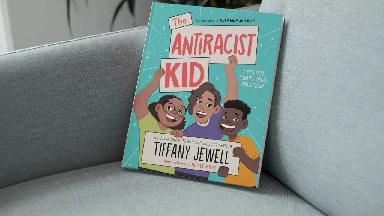 The book Antiracist Kid sitting on a couch