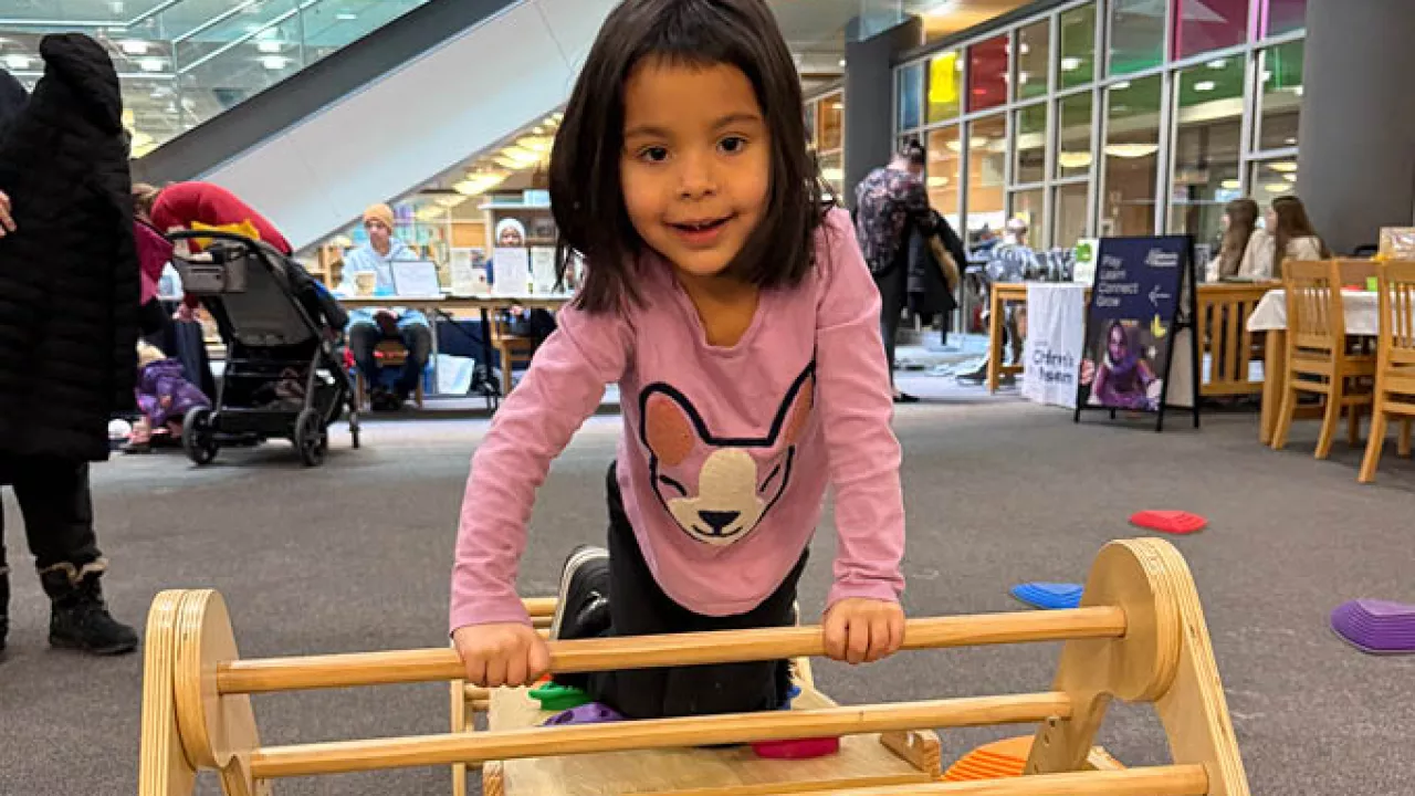 little girl playing at the library