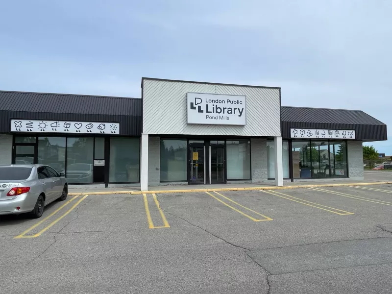 A photo of the outside of Pond Mills Branch Library with a car parked in front.