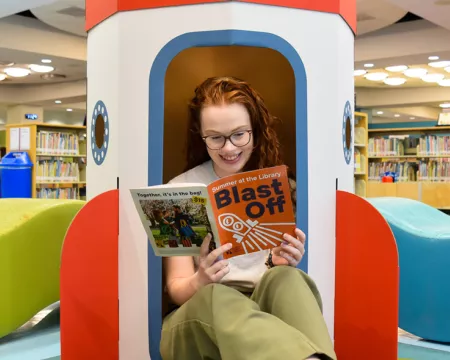 Library staff reading our summer flyer