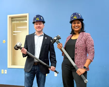 Ward 7 Councillor Corrine Rahman and Mayor Josh Morgan hold sledgehammers at Sherwood library.