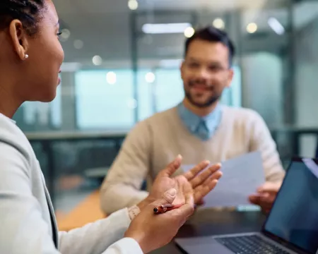 A financial advisor counselling 2 people 