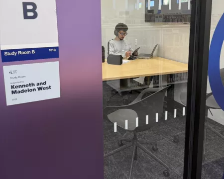 A person working in a study room at Sherwood Branch Library
