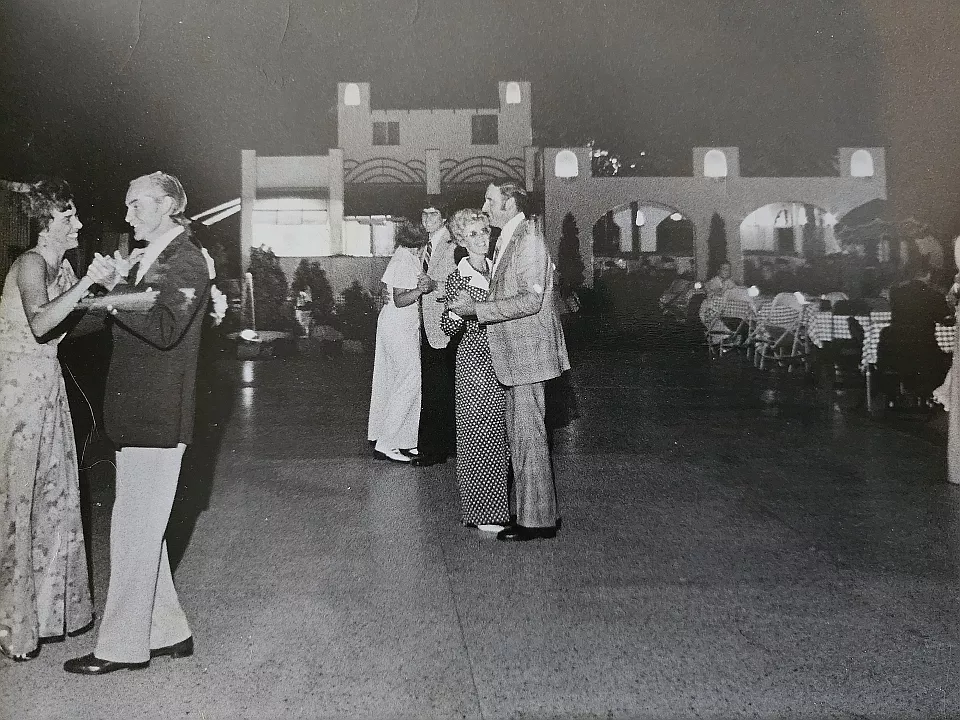 Black and white photo of couples dancing outside at Wonderland Gardens.