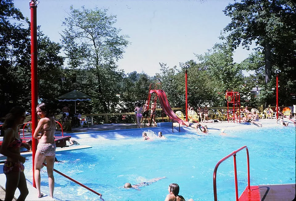 Colour photo of the pool at Wonderland Garden filled with swimmers.