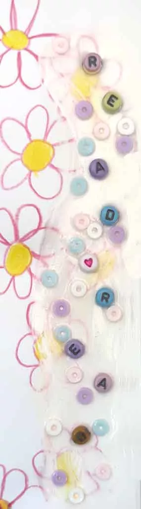 Illustrated flowers and coloured beads on a bookmark