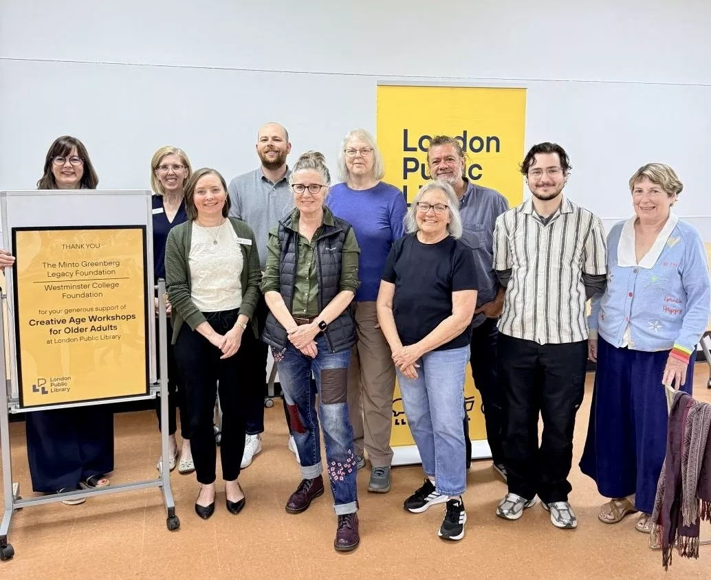 Ten people stand smiling beside a sign recognizing The Minto Greenberg Legacy Foundation and Westminster College Foundation.